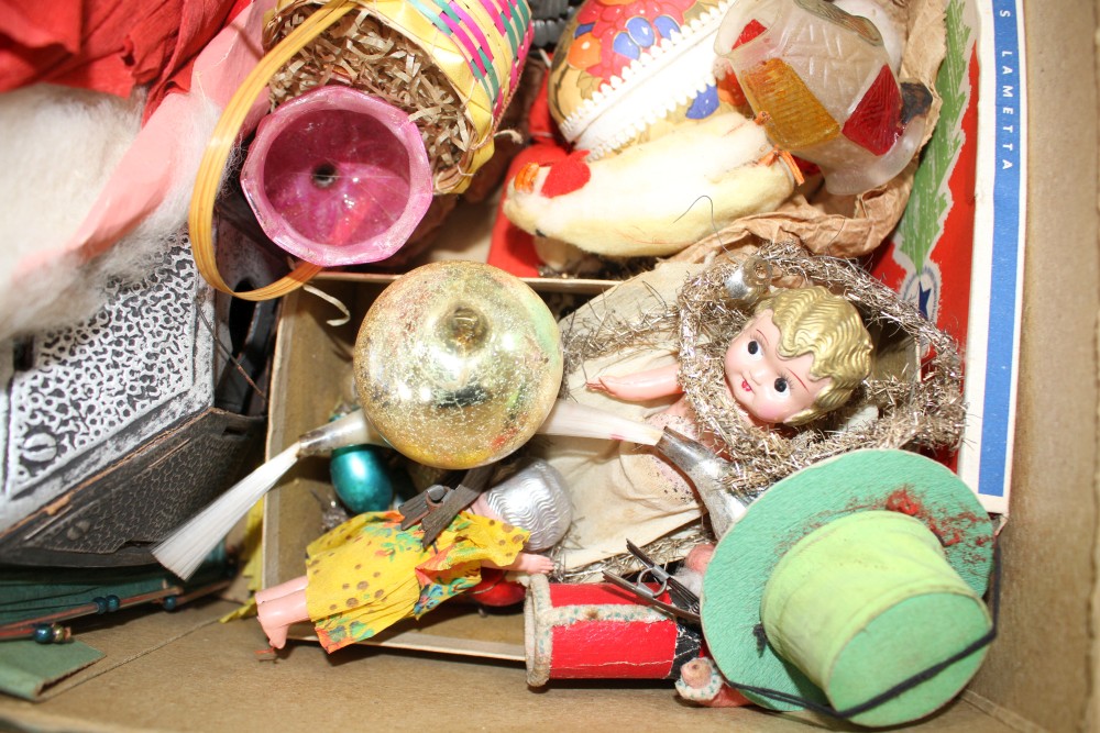 A collection of assorted curios, mostly vintage Christmas decorations but including masks and paper cut-outs